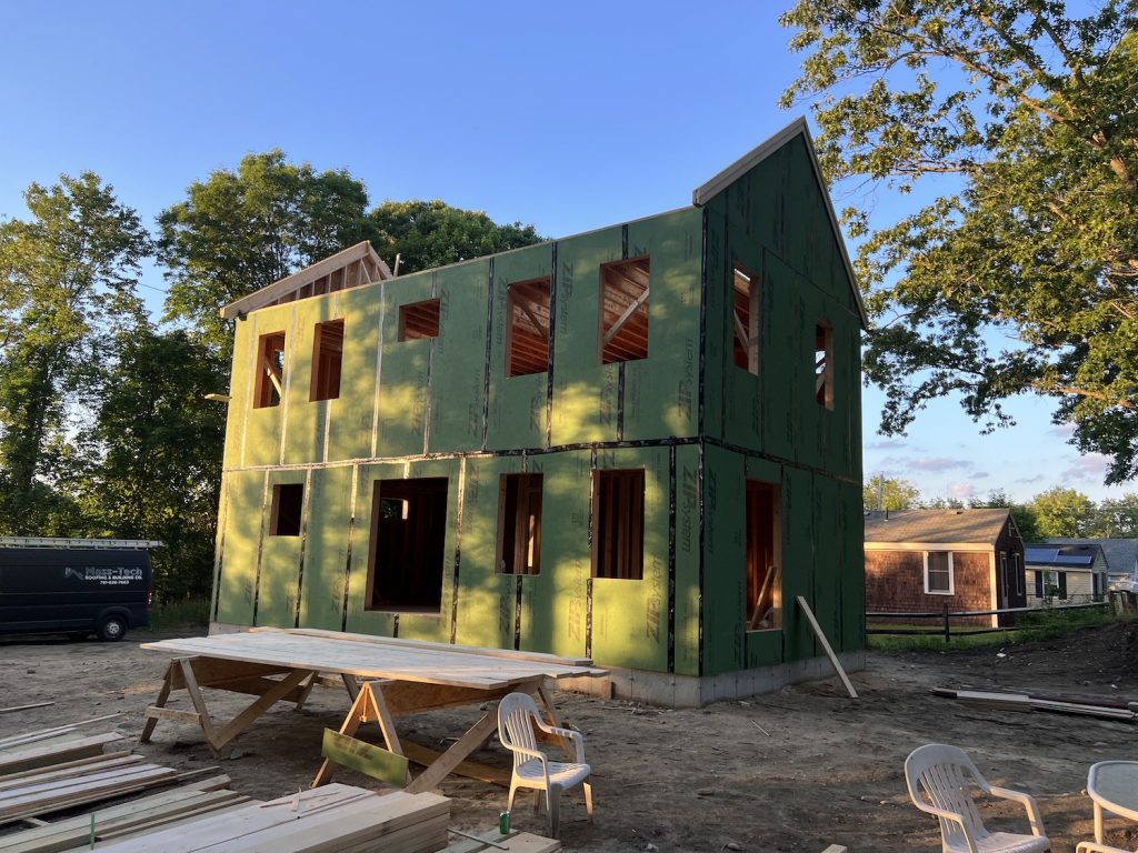 A framed home with no roof showing zip system siding in green