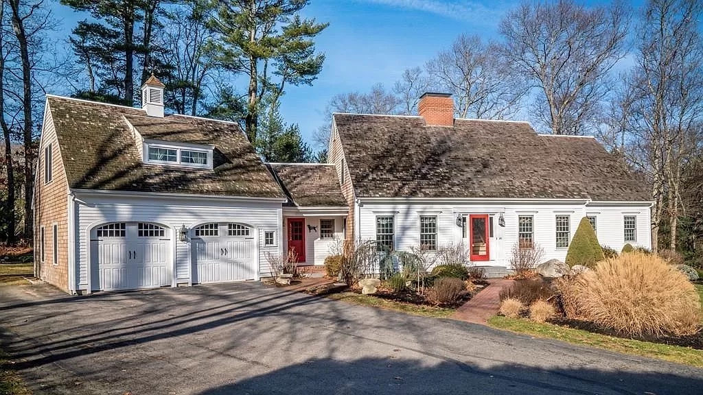 White antique style home with cedar shingles